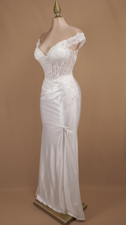 Vestido de novia estilo sirena con corsé traslúcido y falda satinada con abertura