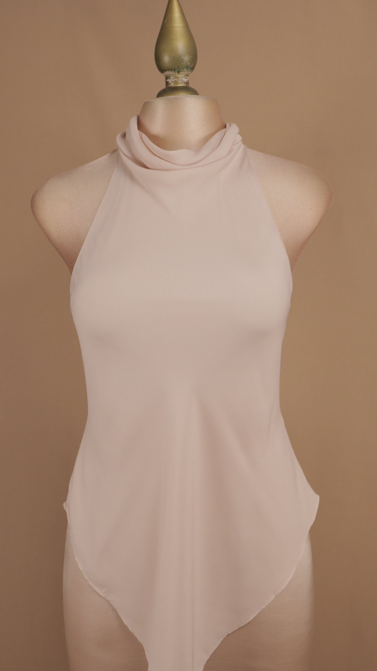 Vestido de noche largo minimalista de efecto superpuesto con cuello halter y bajo asimétrico.